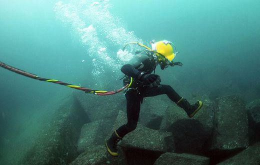 A diver repairing an undersea cable