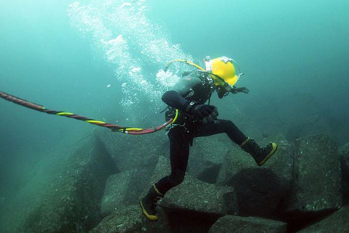 A diver repairing an undersea cable