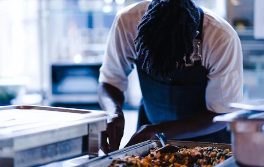 A chef cooking photo credits - Okay Africa