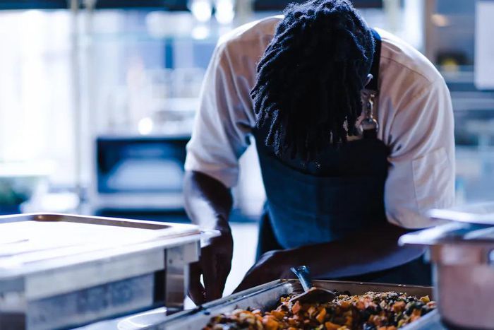 A chef cooking photo credits - Okay Africa