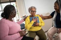 A woman in mourning being comforted