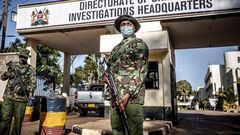 Police officers monitor the entrance to the DCI headquarters.  (Image- The Washington Post)
