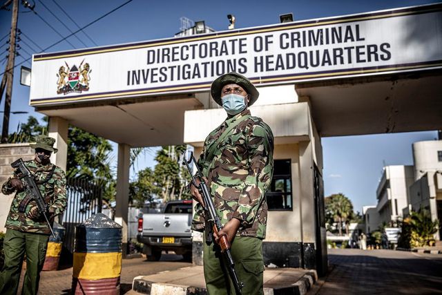 Police officers monitor the entrance to the DCI headquarters.  (Image- The Washington Post)