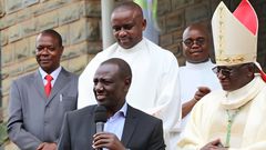 President William Ruto presenting a donation to Embu Catholic Bishop Paul Kariuki during a past service
