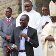 President William Ruto presenting a donation to Embu Catholic Bishop Paul Kariuki during a past service