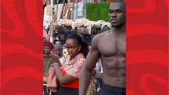 Shirtless fitness coach strolling in Kampala