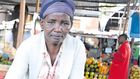 Pauline Waithira selling avocados in the market