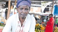 Pauline Waithira selling avocados in the market