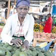 Pauline Waithira selling avocados in the market