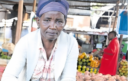 Pauline Waithira selling avocados in the market