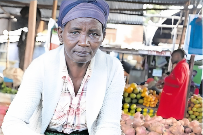 Pauline Waithira selling avocados in the market