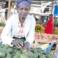 Pauline Waithira selling avocados in the market