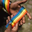 Man showing LGBTQIA ribbon on hand [Photo: Anete Lusina]