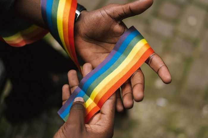 Man showing LGBTQIA ribbon on hand [Photo: Anete Lusina]