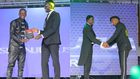 A collage image of Njugush receiving his award from CA’s Ezra Chiloba and Abel Mutua receiving his award from CS Ababu Namwamba