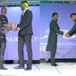 A collage image of Njugush receiving his award from CA’s Ezra Chiloba and Abel Mutua receiving his award from CS Ababu Namwamba