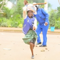 Viral photo of an elderly woman running past a police officer in Kisii during the Saba Saba protests (Courtesy)