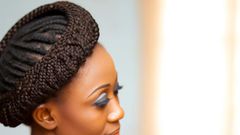 DALL·E 2024-05-08 125051 - Image of an African woman with Halo Braids hairstyle The woman is dressed in a refined, elegant dress suitable for formal occasions The hairstyle fe