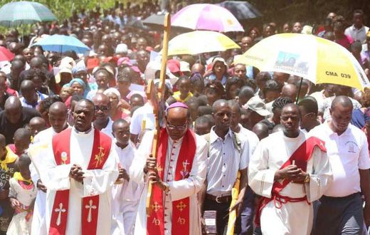 Nyeri Catholic Archbishop Antony Muheria carries a cross as led other faithful in a religious procession to Our Lady of Constanta Cathedral in Nyeri during a past event