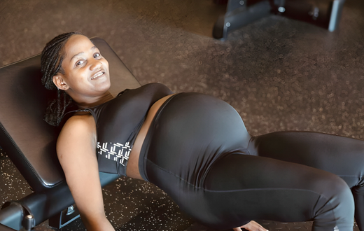 An expectant woman working out
