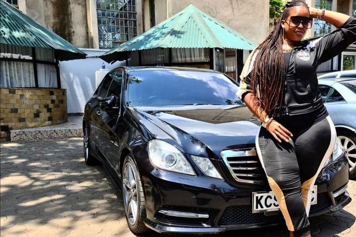 Kiss FM presenter Kamene Goro poses in front of her black Mercedes Benz