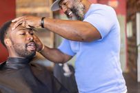 A man getting a haircut in a barbershop
