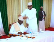 Defence CS Aden Duale adjusting President William Ruto's Kufi during iftar dinner at KICC on April 11, 2023