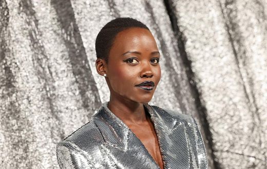 Oscar winner Lupita Nyong'o posed against the silver backdrop in a sequinned silver blazer dress.