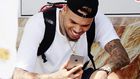 Chris Brown staring at his phone