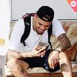 Chris Brown staring at his phone
