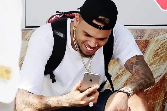 Chris Brown staring at his phone