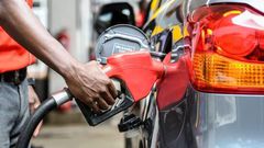 Attendant putting fuel in a car