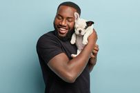 A man with enjoying time with his pet dog