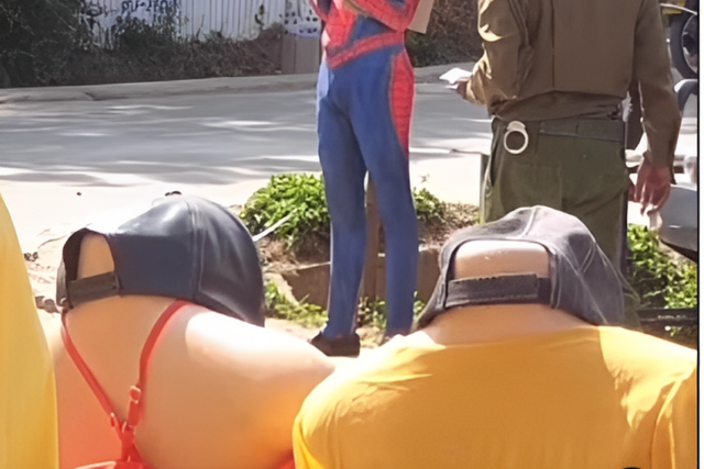 Police officer approaching 'Spider Man'