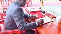 President William Ruto signs his oath of office during his swearing in ceremony in 2022