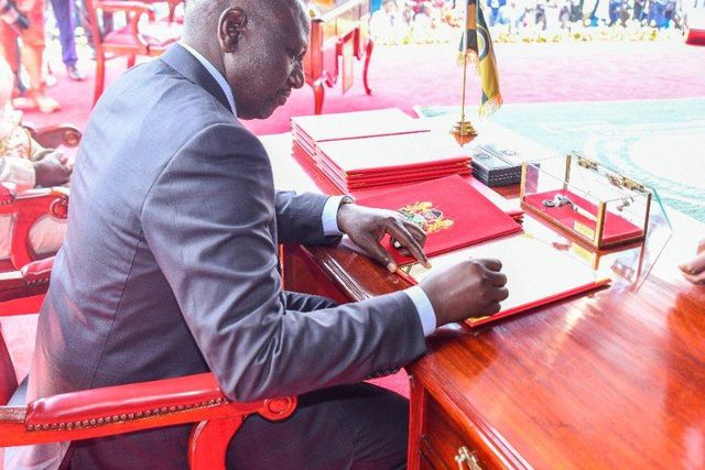 President William Ruto signs his oath of office during his swearing in ceremony in 2022