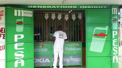A person visiting an M-PESA shop