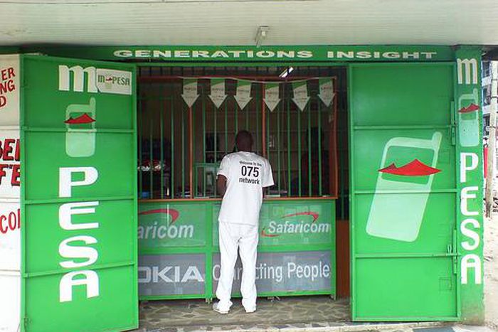 A person visiting an M-PESA shop