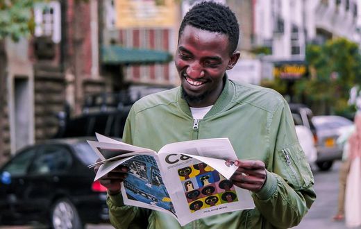 A photo of a man reading a booklet. Photo credits: Pixabay
