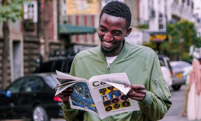 A photo of a man reading a booklet. Photo credits: Pixabay