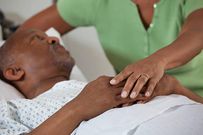 A stock photo of wife comforting husband in hospital - stock photo