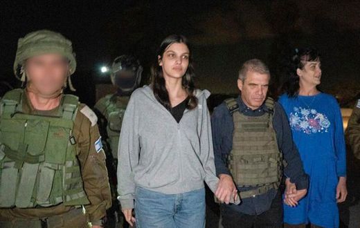 In this photo provided by the Government of Israel, Judith Raanan, right, and her 17-year-old daughter Natalie are escorted by Israeli soldiers and Gal Hirsch, Prime Minister Benjamin Netanyahu's special coordinator for returning the hostages, as they ...