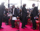 Collage image of former Prime Minister Raila Odinga exchanging greetings with Deputy President Rigathi Gachagua and President William Ruto during the funeral service of the late Mukami Kimathi