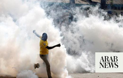 A protestor being tear gased
