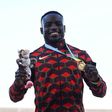 Gold medallist Kenya's Ferdinand Omanyala celebrates during the medal ceremony for the men's 100m athletics event at the Alexander Stadium, in Birmingham on day seven of the Commonwealth Games in Birmingham, central England, on August 4, 2022. (Photo b...
