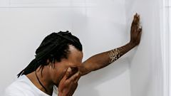 Man crying in the bathroom