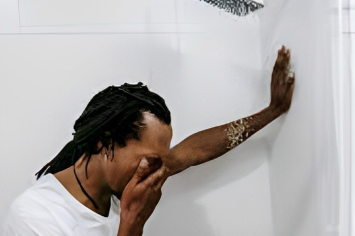 Man crying in the bathroom