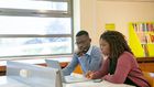 Students preparing a presentation for studies in a classroom [Image: Kampus Production]
