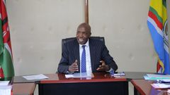 Ezekiel Machogu chairs a meeting in his office