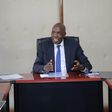Ezekiel Machogu chairs a meeting in his office